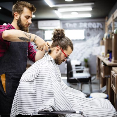 young-bearded-man-getting-haircut-by-hairdresser-w-2021-08-29-09-42-52-utc