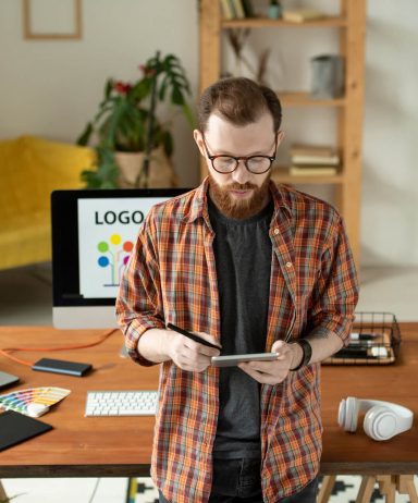 designer-checking-sketch-on-tablet-HRUEST4