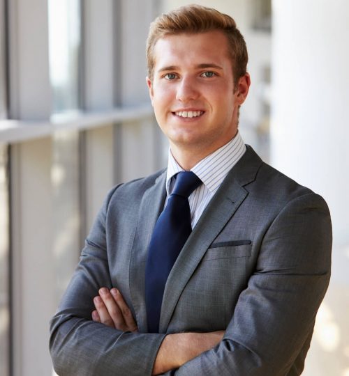 portrait-of-a-young-smiling-professional-man-arms--P9P4F5Q